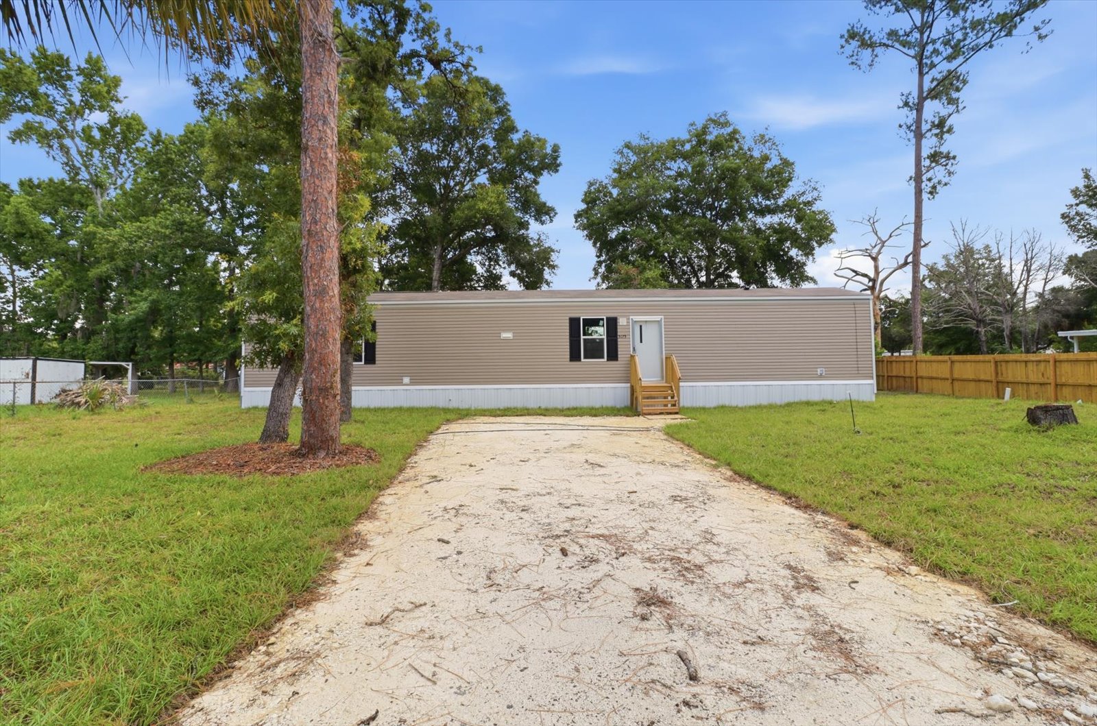 Quick Start Homes single-wide: exterior with sod and landscaping